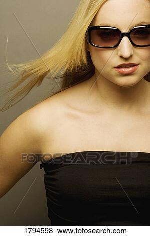 Stock Photo - Woman wearing sunglasses. Fotosearch