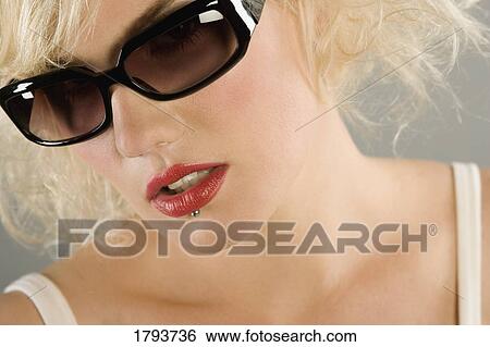 Woman wearing sunglasses View Large Photo Image Stock Photograph - Woman wearing sunglasses. Fotosearch
