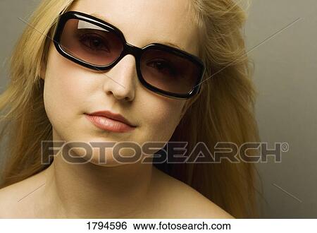 Woman wearing sunglasses View Large Photo Image Stock Photograph - Woman wearing sunglasses. Fotosearch