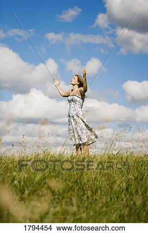 Picture - Woman with arms raised. Fotosearch