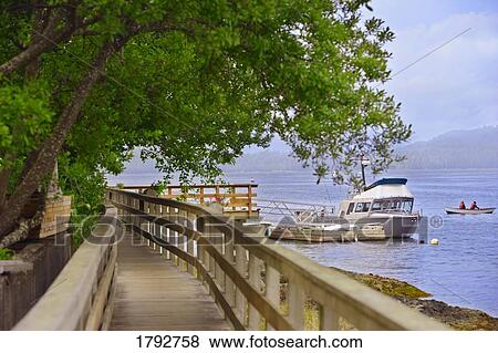 Stock Photo - Wooden walkway and boats. Fotosearch