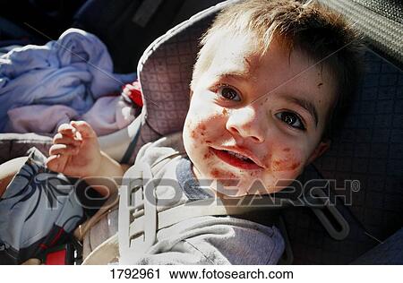 Young boy enjoying food View Large Photo Image Stock Image - Young boy enjoying food. Fotosearch