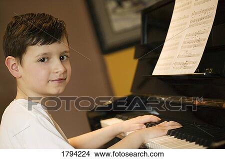 Young boy playing piano View Large Photo Image Picture - Young boy playing piano. Fotosearch