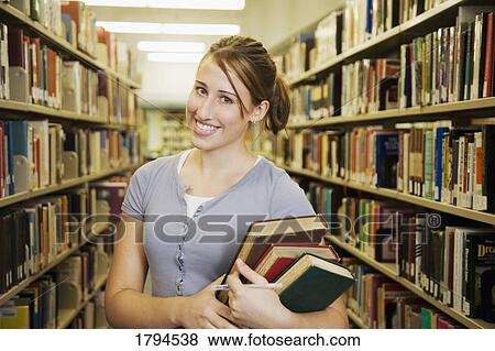 Stock Photo - Young girl in library. Fotosearch