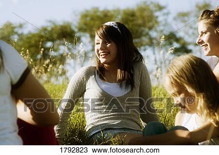 Young girls talking outdoors View Large Photo Image Stock Image - Young girls talking outdoors. Fotosearch