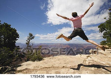 Young man jumping View Large Photo Image Stock Photograph - Young man jumping. Fotosearch
