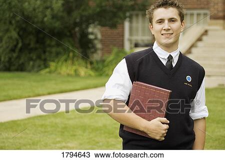 Young man outside of school View Large Photo Image Stock Image - Young man outside of school. Fotosearch