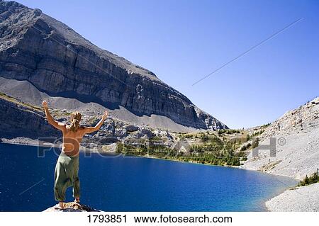 Stock Image - Young man raising hands. Fotosearch