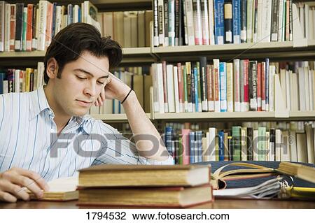 Stock Image - Young man studying. Fotosearch