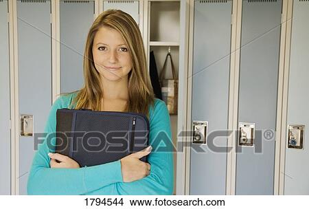 Picture - Young woman at school locker. Fotosearch