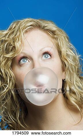 Young woman blowing a bubble View Large Photo Image Stock Photo - Young woman blowing a bubble. Fotosearch