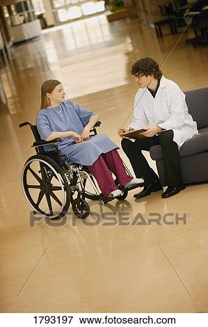Young woman in wheelchair consulting with doctor View Large Photo Image Stock Photo - Young woman in wheelchair consulting with doctor. Fotosearch