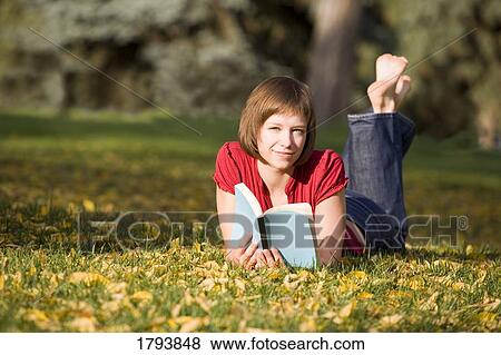 Stock Photo - Young woman reading book. Fotosearch
