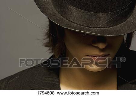 Young woman wearing top hat View Large Photo Image Stock Photo - Young woman wearing top hat. Fotosearch