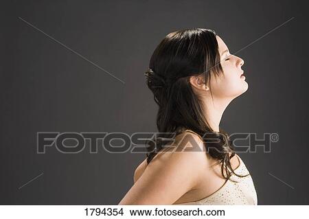 Picture - Young woman with eyes closed. Fotosearch