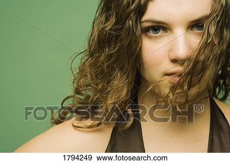 Young woman with hair in front of face View Large Photo Image Stock Photo - Young woman with hair in front of face. Fotosearch