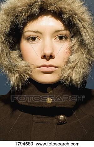 Stock Image - Young woman with winter coat. Fotosearch