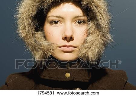 Stock Image - Young woman with winter coat. Fotosearch