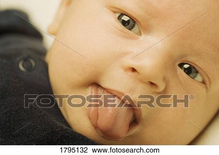 Stock Image - Baby boy sticking tongue out. Fotosearch