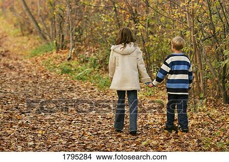 Boy and girl holding hands View Large Photo Image Picture - Boy and girl holding hands. Fotosearch