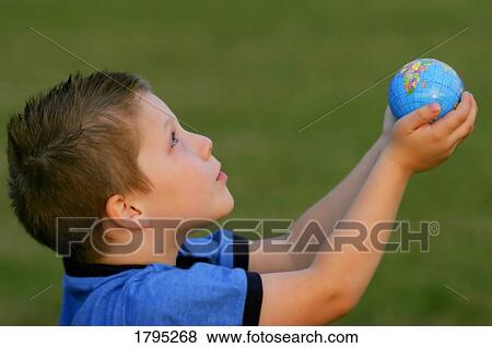 Stock Photo - Boy offering the world. Fotosearch