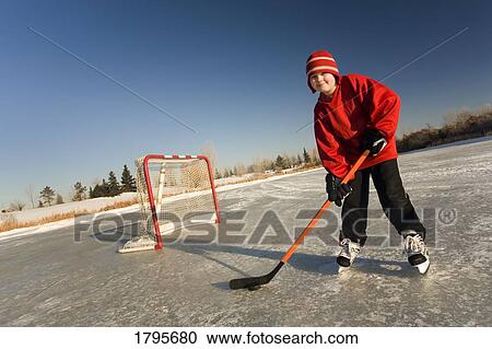 Stock Image - Boy playing hockey. Fotosearch