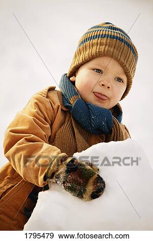 Stock Photo - Boy playing in the snow. Fotosearch