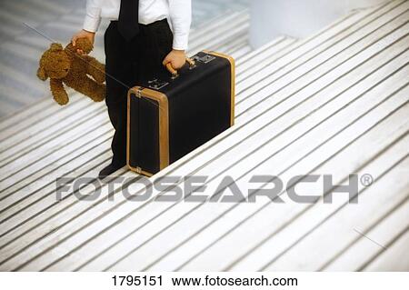 Stock Image - Boy travelling alone. Fotosearch