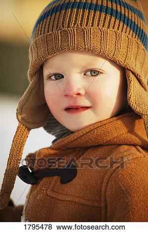 Stock Photo - Boy wearing winter clothing. Fotosearch