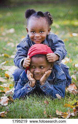 Brother and sister playing in the fall grasses View Large Photo Image Stock Photo - Brother and sister playing in the fall grasses. Fotosearch