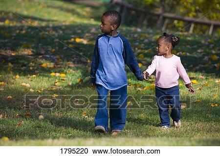 Brother and sister walking together View Large Photo Image Stock Image - Brother and sister walking together. Fotosearch
