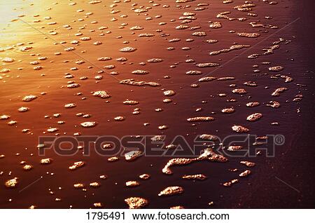Stock Image - Bubbles on the sand. Fotosearch