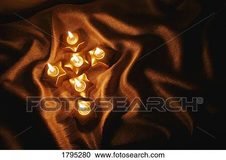 Stock Image - Candles in the shape of a cross. Fotosearch