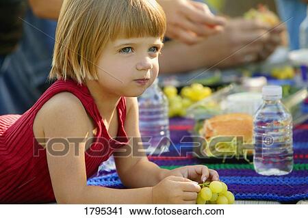 Stock Image - Child at a picnic. Fotosearch