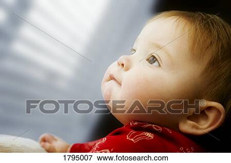 Stock Photo - Child looking out window. Fotosearch