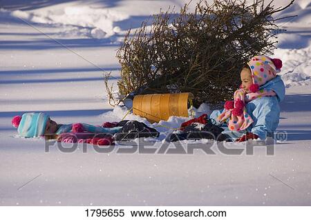 Stock Photography - Girls resting in the snow. Fotosearch