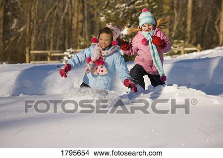 Picture - Girls running in the snow. Fotosearch
