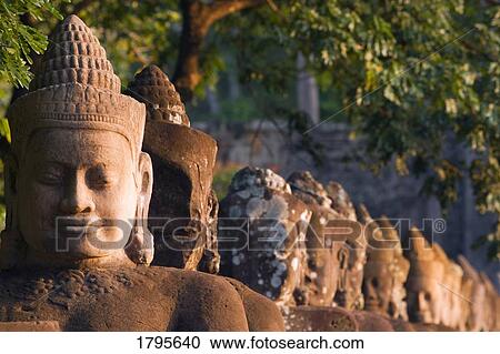 Stock Image - Head statues, Angkor Wat Temple Complex, Angkor Thom, Cambodia. Fotosearch
