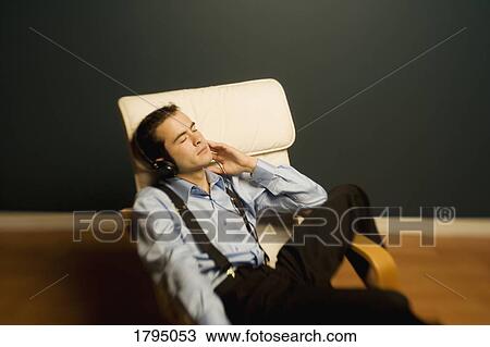 Stock Image - Man sleeping in a chair. Fotosearch
