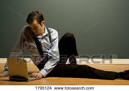 Picture - Man working on a laptop. Fotosearch