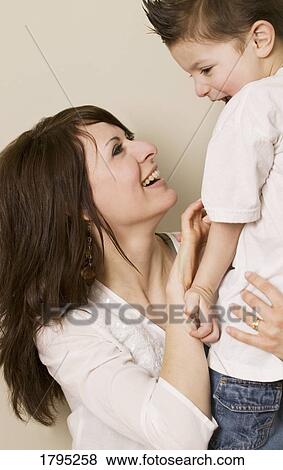 Mother tickling son View Large Photo Image Stock Photo - Mother tickling son. Fotosearch