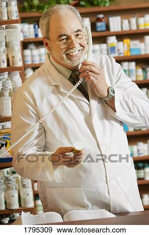 Pharmacist on the phone View Large Photo Image Stock Photo - Pharmacist on the phone. Fotosearch