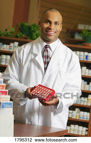 Stock Image - Pharmacist with medicine. Fotosearch