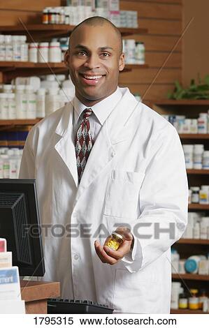 Stock Photography - Pharmacist with medicine. Fotosearch