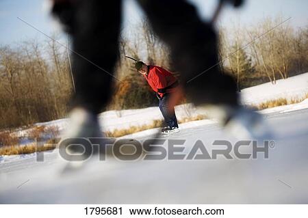 Stock Image - Playing hockey. Fotosearch