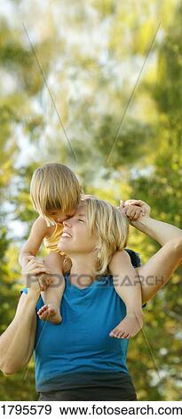 Stock Photo - Ride on parent's shoulder. Fotosearch