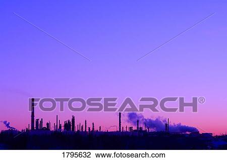 Silhouetted refineries in front of a tinted sky View Large Photo Image Stock Image - Silhouetted refineries in front of a tinted sky. Fotosearch