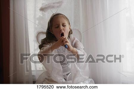 Stock Image - Singing "like an angel". Fotosearch