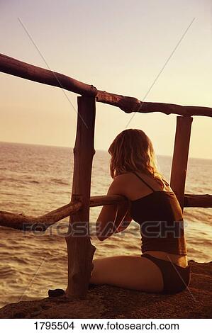 Sitting on the edge View Large Photo Image Picture - Sitting on the edge. Fotosearch
