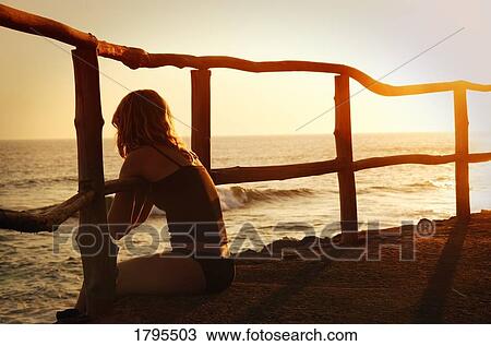 Stock Image - Sitting on the edge. Fotosearch